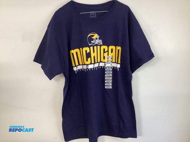 Lot 2-19206 - New University of Michigan Football t-shirt by Pro Edge. Maize and Bluetooth. Men’s size medium.