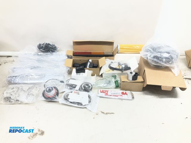 Lot 2-27236 - Lot of various types of car parts including door handles, lights, gas cap, and more.