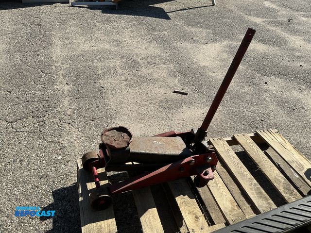 Lot 2-76754 - Older red 5 ton jack 4 wheels not complete handle