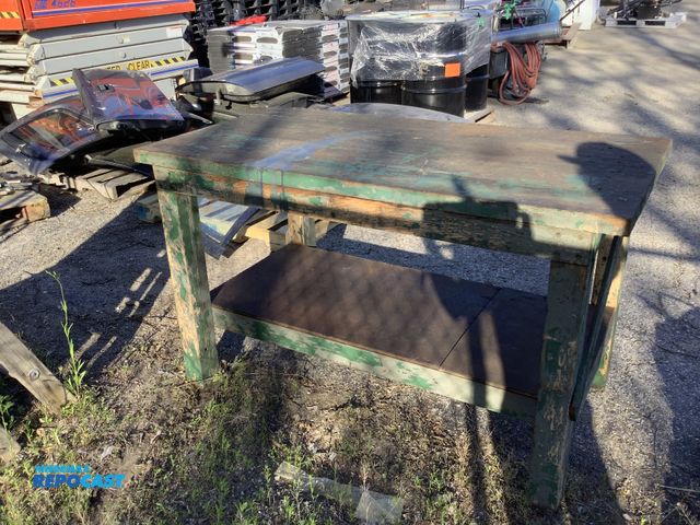 Lot 2-35706 - vintage industrial workbench featuring a green painted wooden frame and a lower storage shelf. Bench...