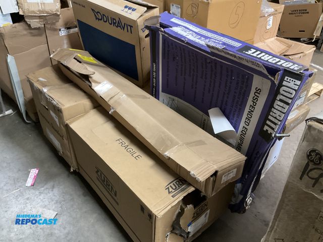 Lot 2-69374 - Skid lot of various plumbing and household materials such as proflo sink pedestal leg, suspended equ...