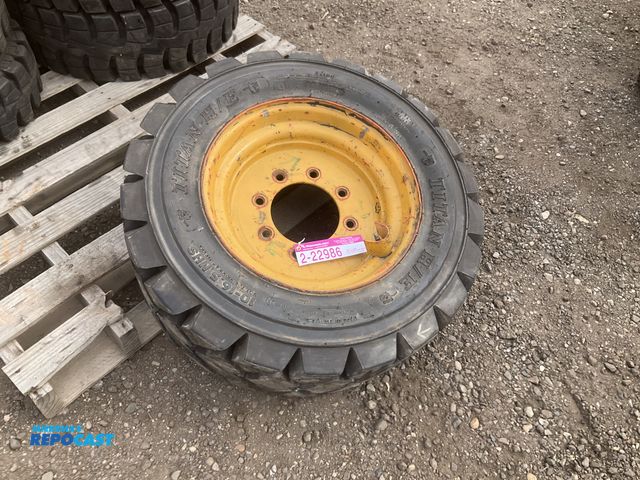 Lot 2-22986 - (1) 10-16.5 skid steer tire on a steel wheel