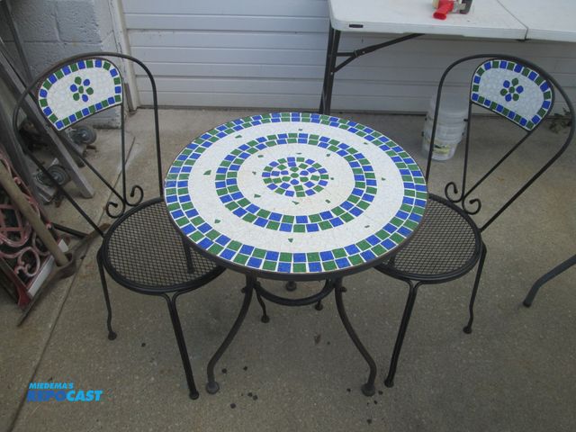 Lot 2-59084 - metal patio/deck table w/ 2 chairs, inlaid tile top on chair backs - table is approx; 24" round
