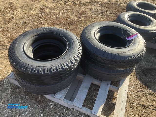 Lot 2-23676 - (4) 8-14.5 tires on steel mobile home style wheels, used, one is flat and off the bead