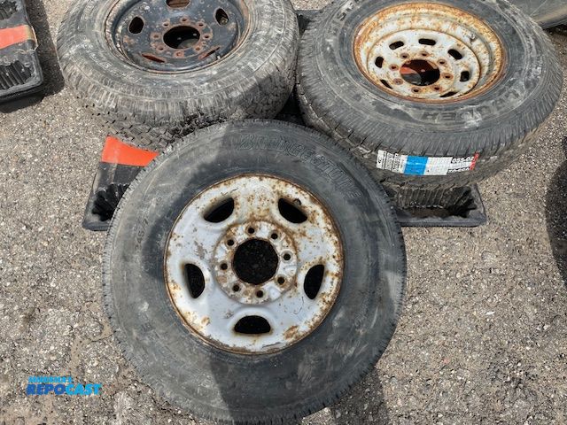 Lot 2-91548 - 3 Used tires on rims, BF Goodrich Rugged T/A LT245/75R17 load range E, Bridgestone V Steel Rib 265, ...