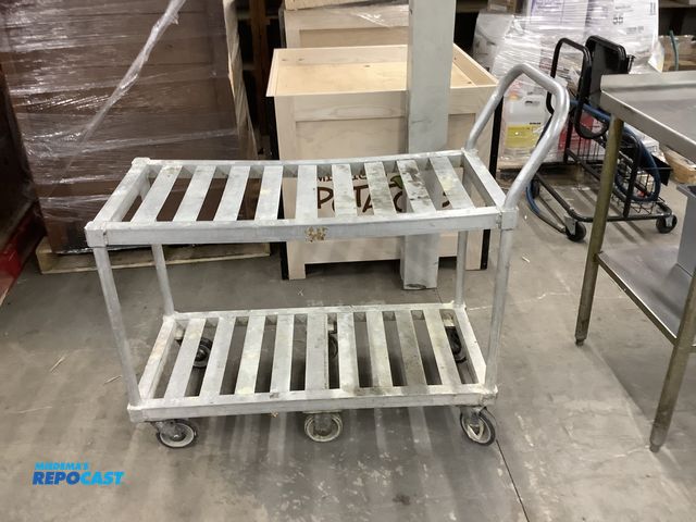 Lot 2-23886 - (1) Aluminum product cart, 6 wheels with push handle, cart is 41” long by 19” wide by 30” tall to to...