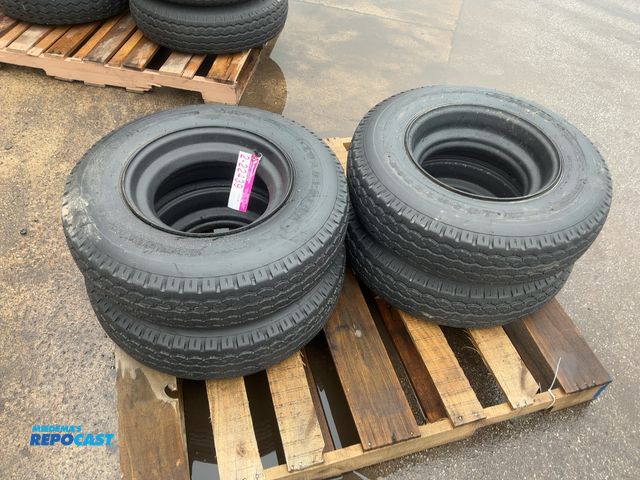Lot 2-22439 - (4) 8-14.5 tires on steel mobile home style wheels, used, one tire flat
