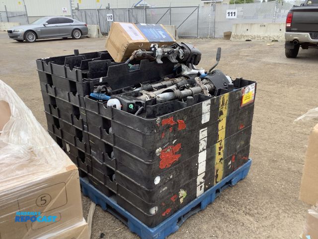 Lot 2-34915 - Skid lot of plastic crates of assorted vehicle steering columns also includes 4pc ronaqua con count ...