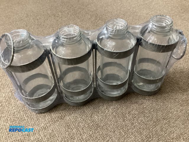 Lot 2-76413 - 4 glass and metal table top vases. By Room and Retreat.
