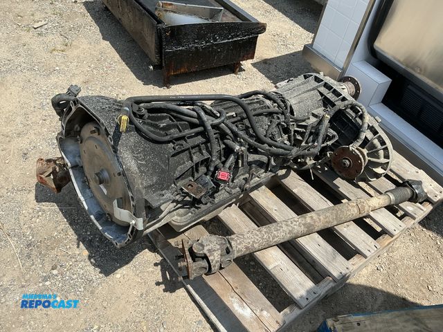 Lot 2-96554 - Skid lot of F250 6-speed trans &amp; transfer case w/ drive shafts