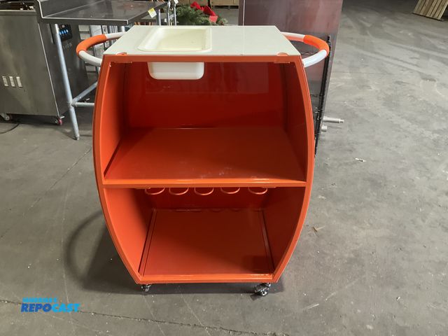 Lot 2-55131 - April Spritz 34” width x 40” height x 20” depth barrel shaped pushcart with 7” x 4” x 16” trough on ...