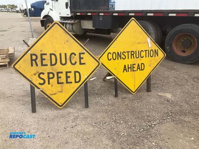 Lot 2-43433 - (2) construction signs with stands, each is approx 49” tall, used