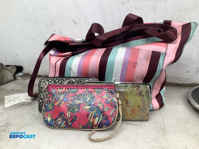 Lot 2-67000 - Pink brown blue and maroon striped bag full of assorted hand bags/purses some with zippers some with...