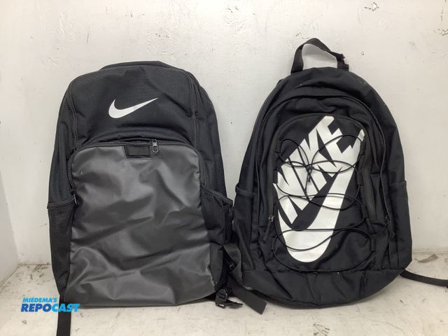 Lot 2-74000 - New (2) new black Nike backpacks, one backpack has (4) pockets, and the second one has (5) pockets