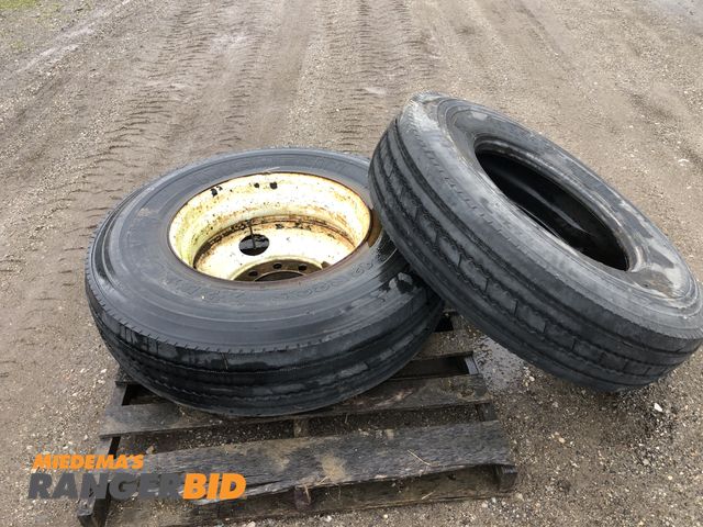Lot 30-28V - 2 (2) 12R22.5 tires, one with 10 bolt rim and one without, see photos for type, tread and condition