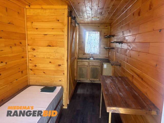 Lot 30-20620 - 8' X 20' Insulated Mini Cabin. 2 single beds, shower, sink, toilet, windows.  New.  Never used