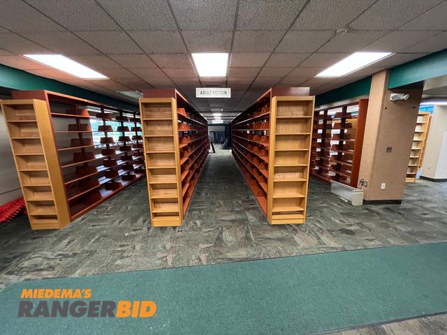 Lot 30-3364 - Library book shelves, 4 sections 30' long and 1 section 21' long. Comes with end shelving and cross brackets. Buyer is responsible for removal.
