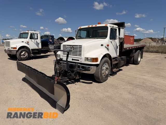 Lot 30-3453 - 1999 International 4700 4x2 with 10' Snow Dogg Plow Flatbed Truck