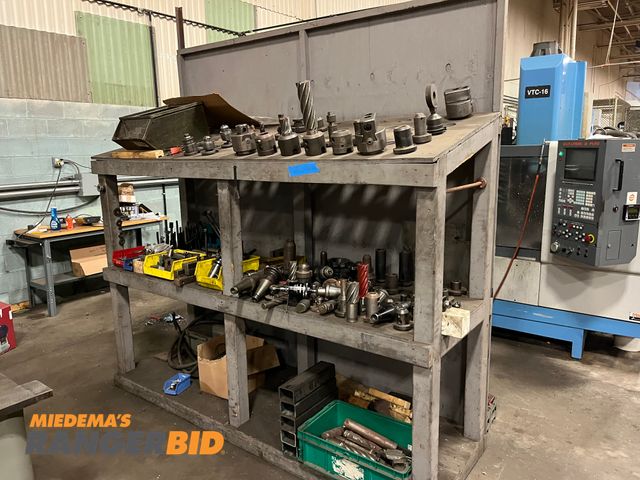 Lot 30-2413 - Lot includes all the cutters and tool holders shown with the racking.  Tool holders are NM...