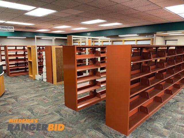 Lot 30-3362 - Lot includes all the metal and wood bookshelves shown. Buyer is responsible for removal.