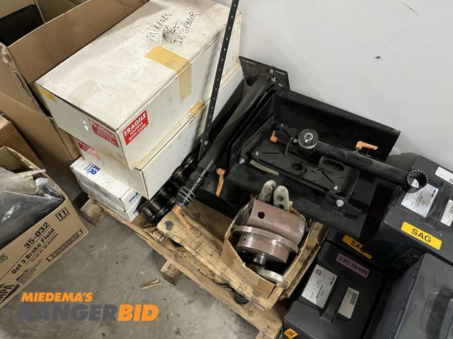 Lot 30-2129 - Lot includes: jump seat, JD gaskets, Mower wheels, CNH Parts, Truck display stand, Bearings, and mor...