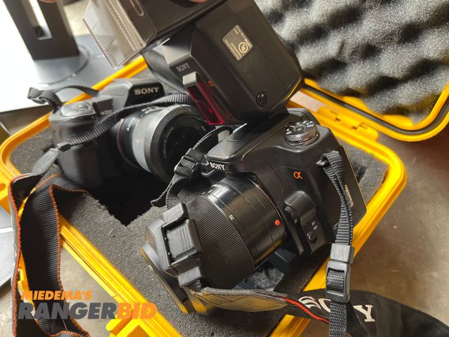 Lot 30-3376 - Lot includes monitor stands as well as 2 Sony digital cameras.