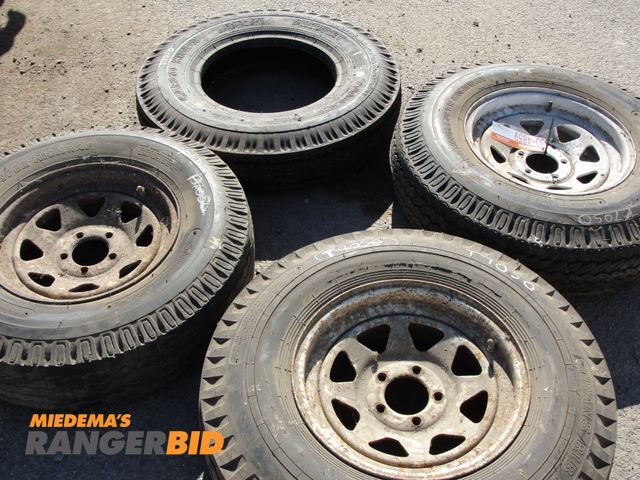 Lot 30-4859 - 4 Tires - 3 new and 1 used, 7.0-15 tires.  3 mounted on wheels and 1 not mounted