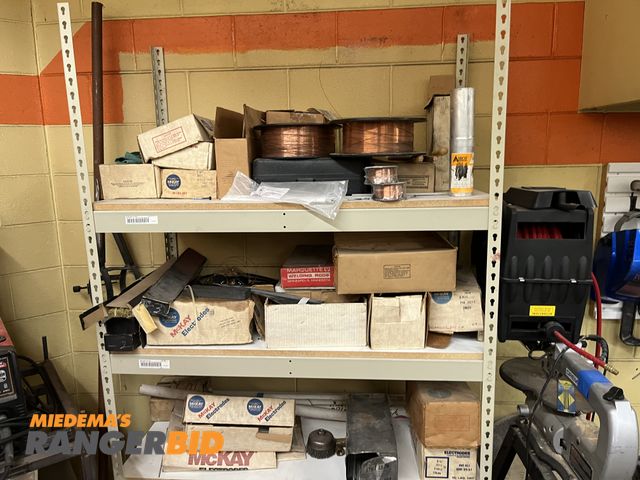 Lot 30-1081 - Rack of Welding Rod, wire, and helmets (rack is included)