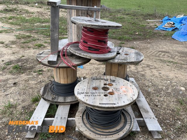 Lot 30-5771 - (1) skid of assorted partial spools of wire with (1) custom built wood wire spool holder, includes 3...