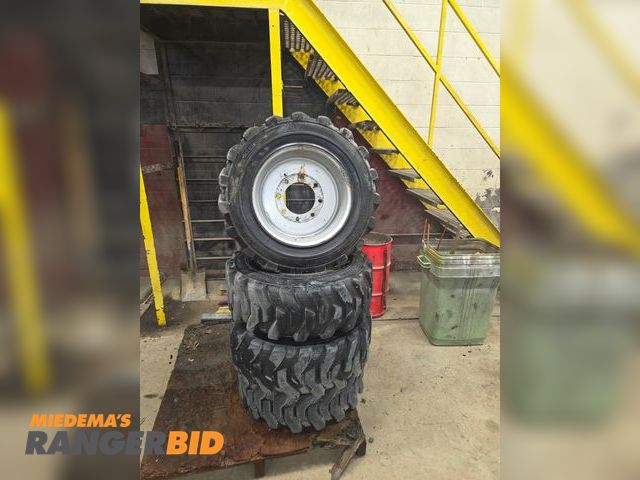 Lot 30-5015 - Tubless wheeled skid steer tires with rims 16.5 x 10 (8) lug
