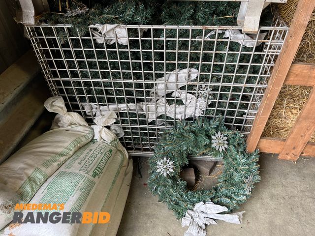 Lot 30-786 - Lot includes (4) bins of Christmas decorations. 2 bins of wreaths and 2 bins of garland. Please not that the metal bins are NOT included.
