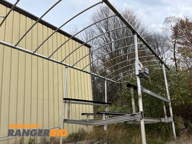 Lot 30-3976 - Shore station with electric lift. Lift works, the posts are all cracked thru. Buyer is res...