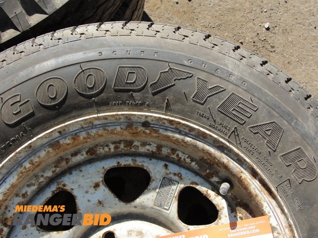 Lot 30-4860 - 2 Tires, 205-75-14; both mounted on wheels.  1 used and 1 new