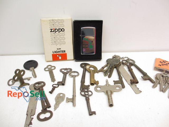Lot 31-2025 - Zippo Slim Lighter with Box and Key Collection - Mostly Skeleton