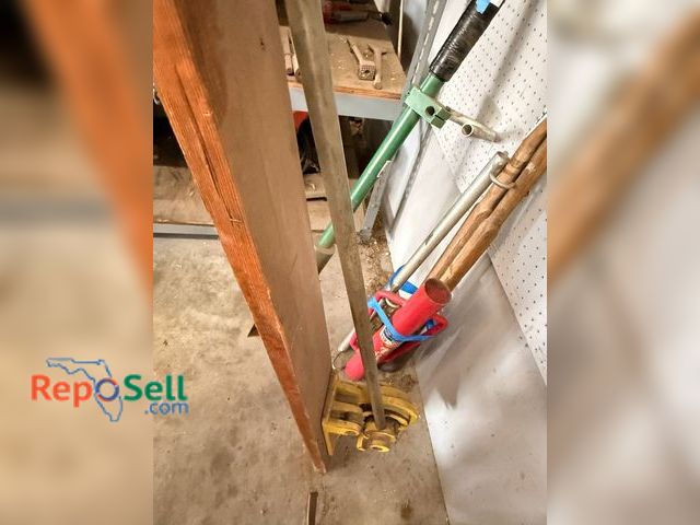 Lot 31-1122 - Heavy-duty conduit bender made of durable metal with a long attached handle for leverage. Designed f...