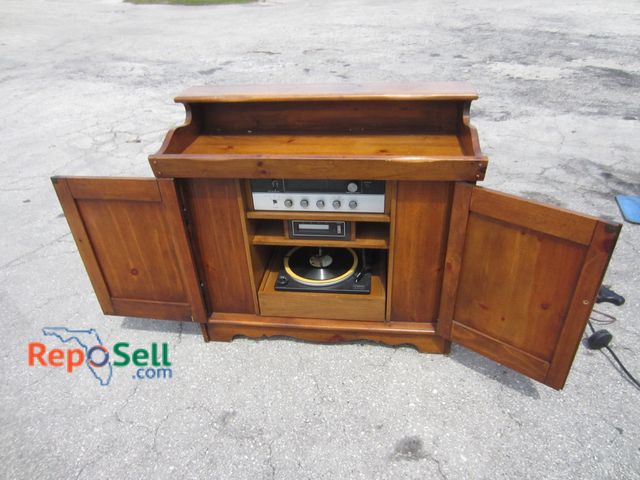 Lot 31-1192 - Magnavox America's record player eight-track cabinet powers on.