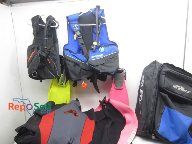 Lot 31-6394 - Large Lot of Scuba Equipment: (2) Bags, (2) Wet Suits, (5) Pairs Fins, (2) B/C's, etc.