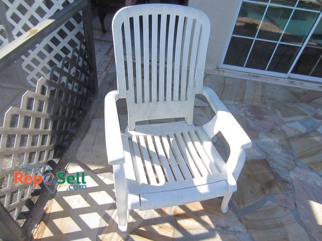 Lot 31-8601 - Single White Plastic Outdoor Deck Chair With Slatted Design