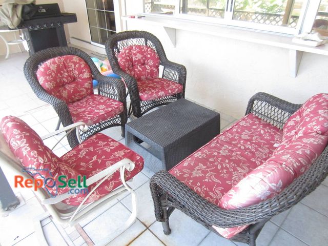 Lot 31-8602 - Five-Piece Wicker Patio Furniture Set With Loveseat, Rocker, Two Chairs, And Table