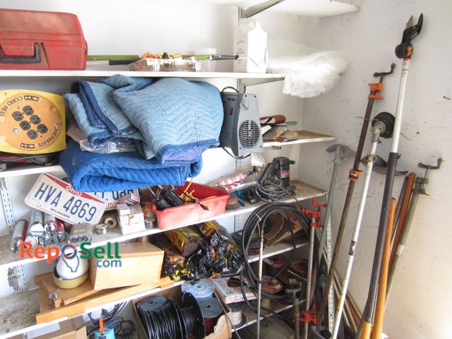 Lot 31-2055 - Contents of Corner / Shelves: Wire, Clamps, Fire Logs, Moving Blankets, etc
