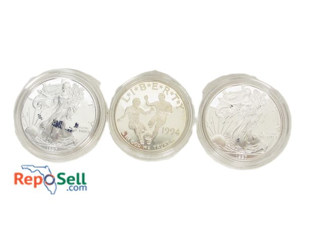 Lot 31-2017 - (3) 1 oz. Silver Dollars: (2) 1997 American Eagle Liberty and (1) 1994 World Cup with COA