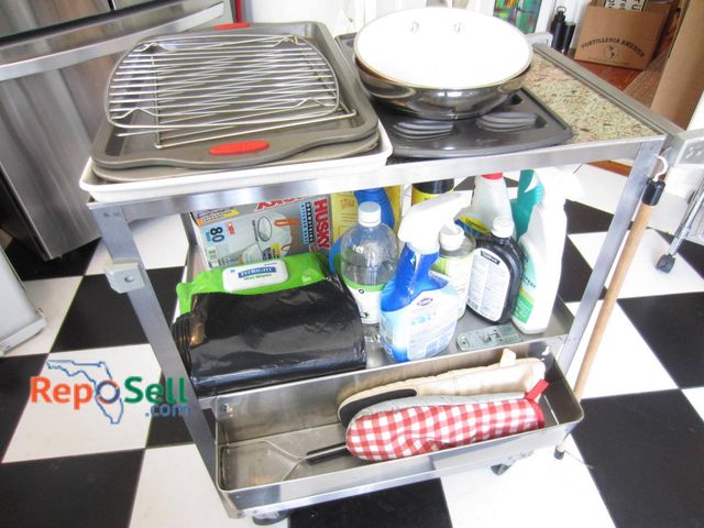 Lot 31-9188 - Lakeside stainless steel utility cart on casters, featuring multiple items including a baking sheet ...