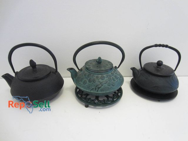 Lot 31-9086 - Three Cast Iron Teapots, One Green With Floral Pattern And Two Black, Includes Lids And Trivets.