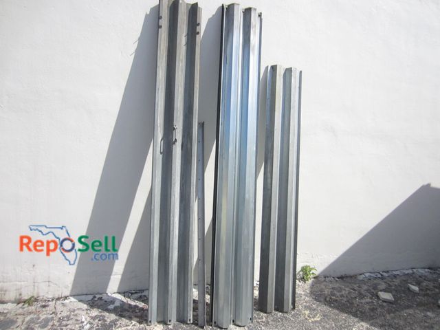 Lot 31-5356 - (12) Galvanized Steel Hurricane Shutters: (11) 104" (1 With Handle In Center), (1) 87" And Aluminum ...