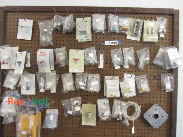 Lot 31-1090 - New pressure washer tips, holders, parts, etc., Items on pegboard.