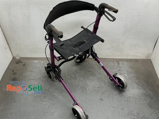 Lot 31-1463 - Purple aluminum rollator walker featuring a folding frame, cushioned hand grips, black mesh seat, an...