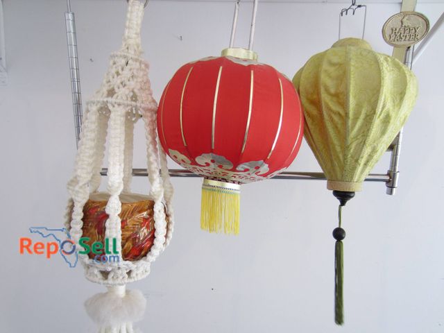 Lot 31-9139 - Four hanging decorative lanterns including a macrame holder with a red glass votive, a red lantern w...