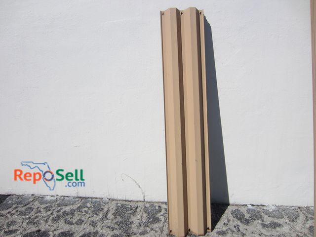 Lot 31-7230 - (25) 71" Metal Storm Shutters - Painted Tan on One Side