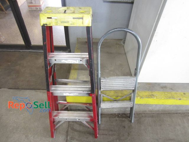 Lot 31-1381 - A Werner Step Ladder With A Yellow Top And Red Aluminum Frame, And A Silver Aluminum Step Ladder Wit...