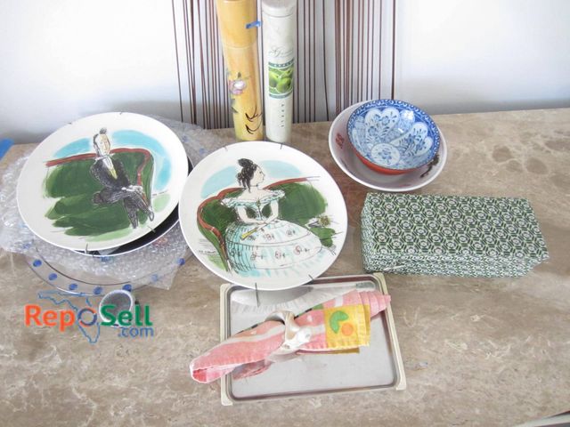 Lot 31-9191 - Lot including two ceramic plates featuring hand-painted depictions of figures seated on green furnit...